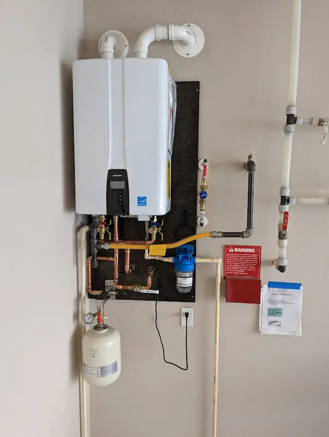 Professional plumber installing copper piping in a Trinity home